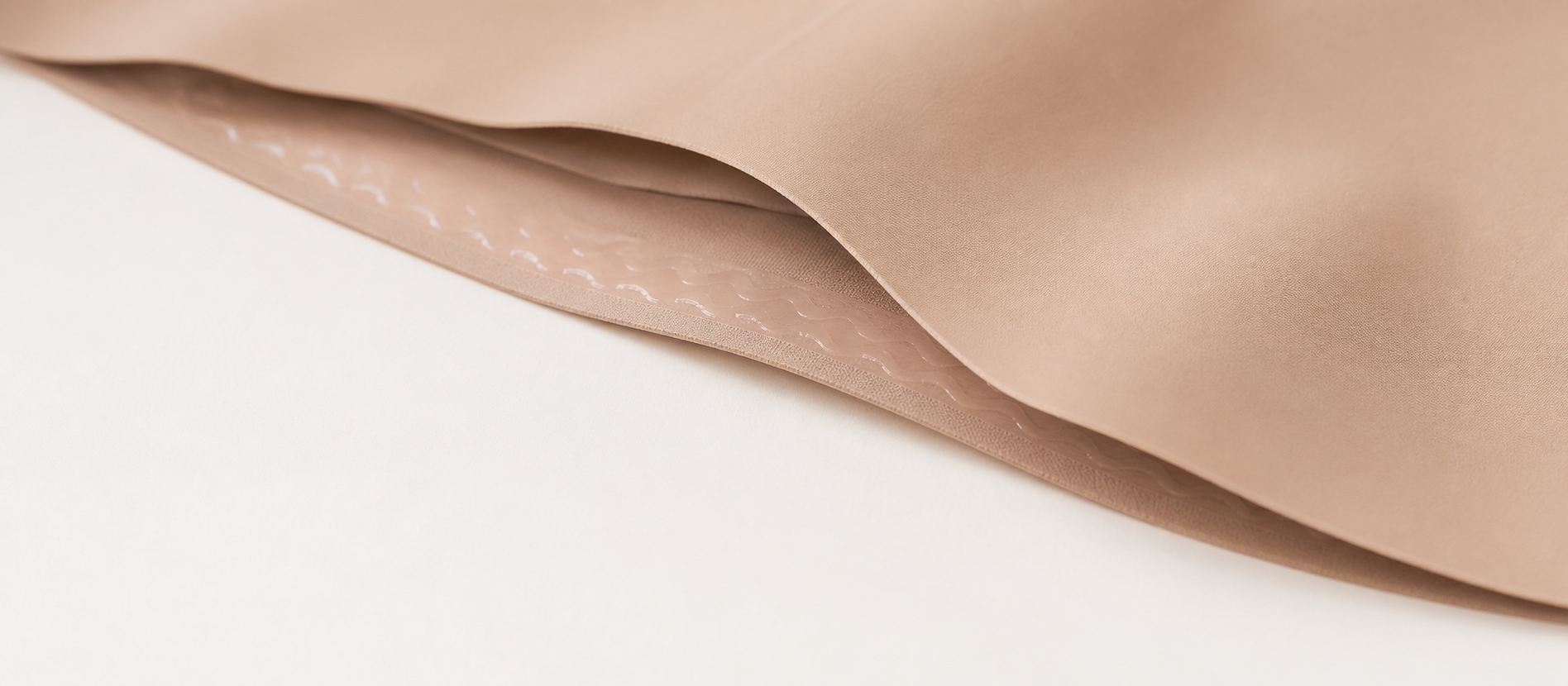 Bonded laser-cut edge of nude shapewear close-up